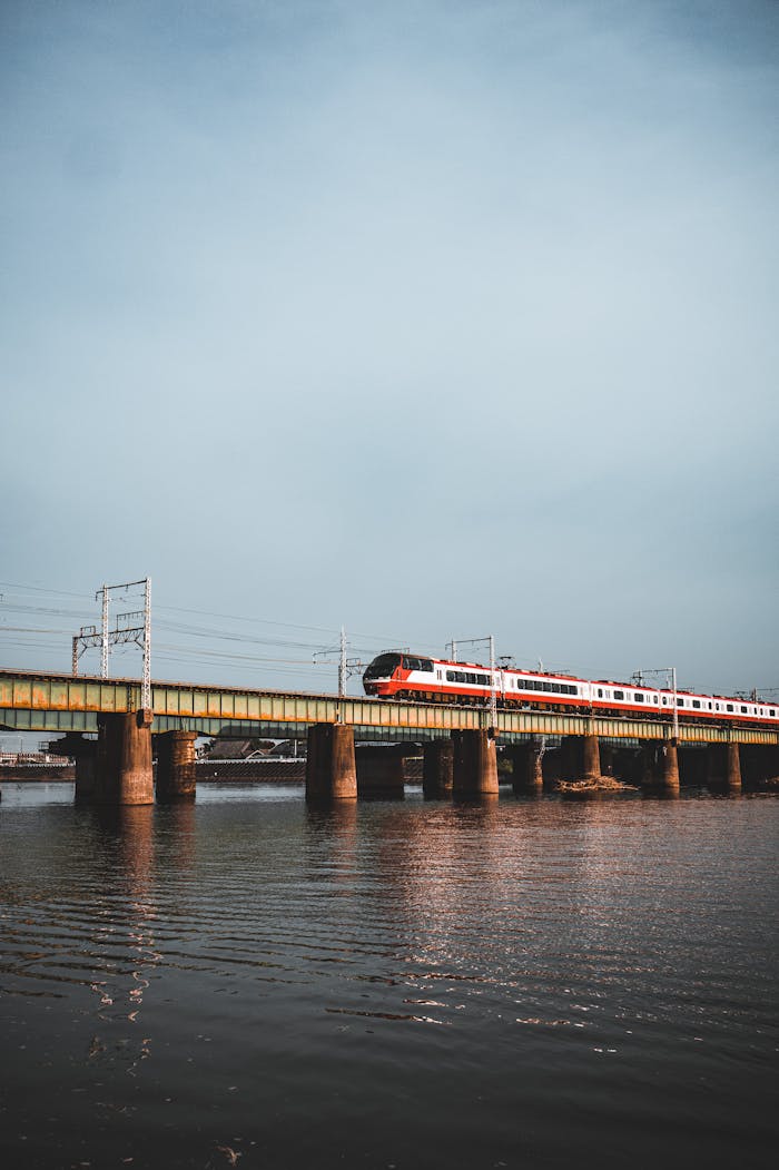 A scenic view of a train crossing a railway bridge in Toyohashi, Japan.