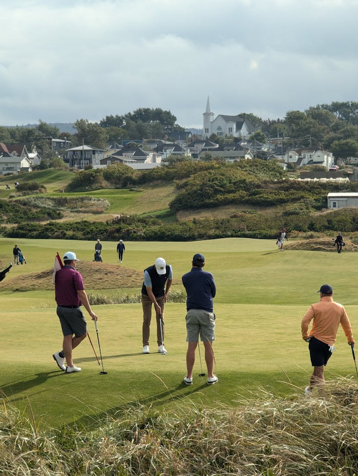 Amateur golfers playing on a scenic course in Cape Breton Island, Nova Scotia.